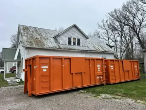 Two Rubble Jockey dumpsters staged in front of a house before demolition on a Spencer Pike project in Mt. Sterling